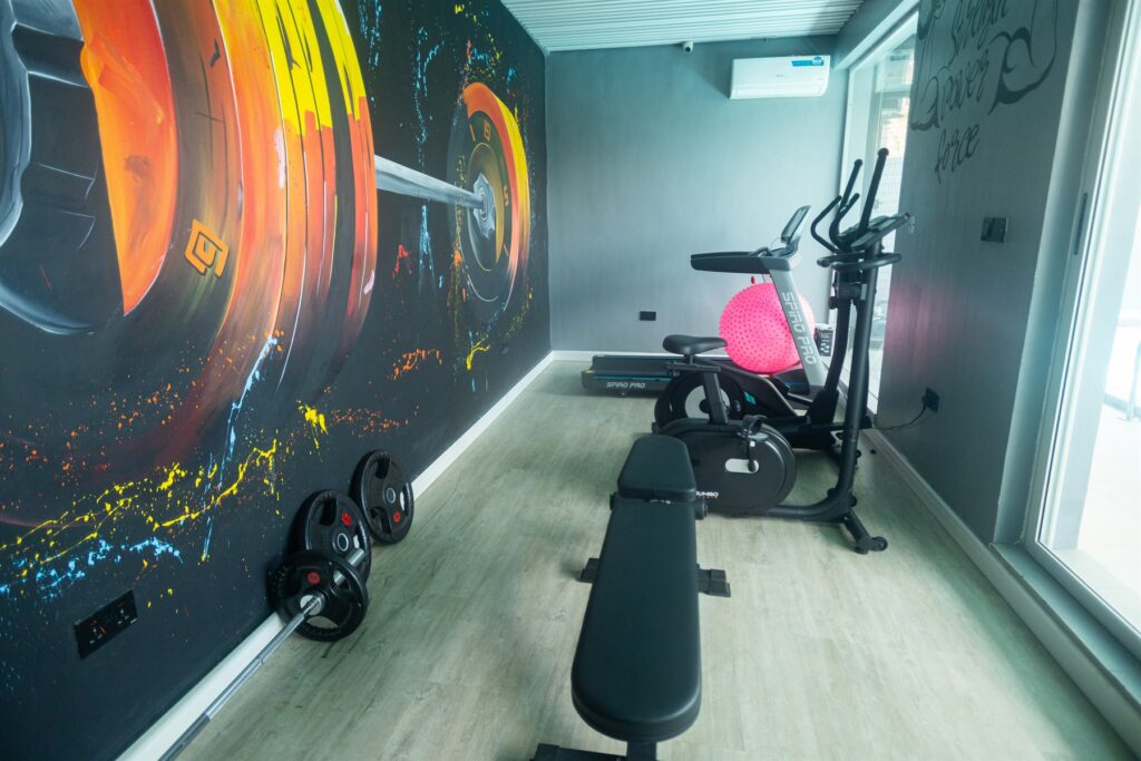 Brum Height 6: Gym interior with a workout bench and exercise bicycle